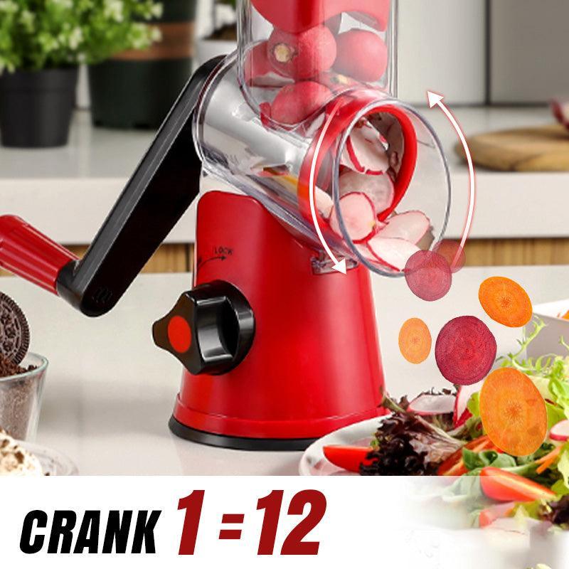 Red manual vegetable slicer with crank, slicing radishes and carrots on a kitchen counter.