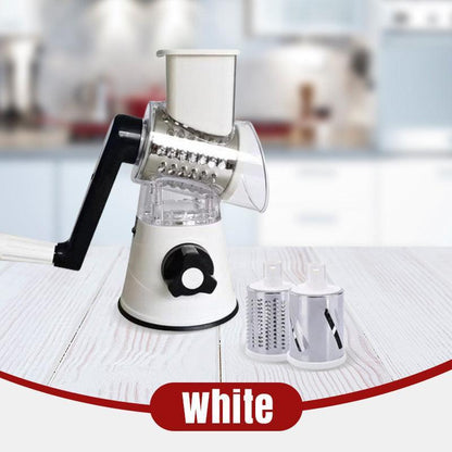 White manual rotary cheese grater with interchangeable stainless steel blades on kitchen counter