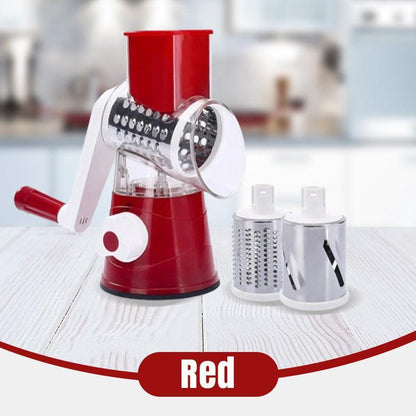 Red rotary manual grater with interchangeable stainless steel drums on kitchen table